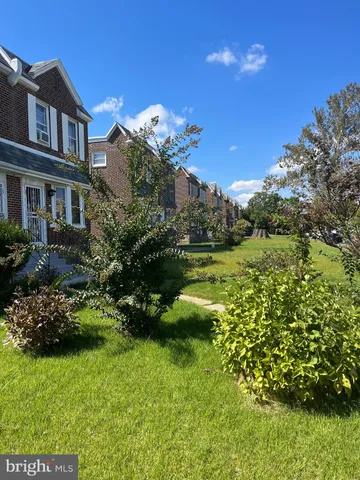 a view of a house with a big yard and potted plants