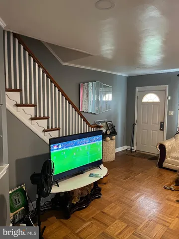 a room with stairs and a wooden floor