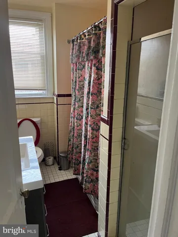 a view of a bathroom with a shower and a sink