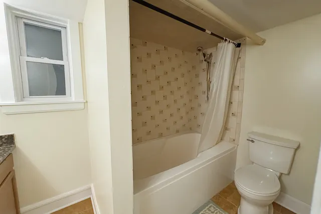 a bathroom with a toilet and a bathtub