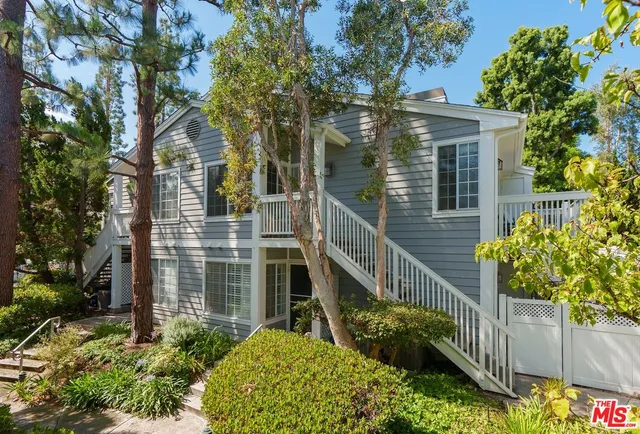 a view of a house with brick walls and flower plants