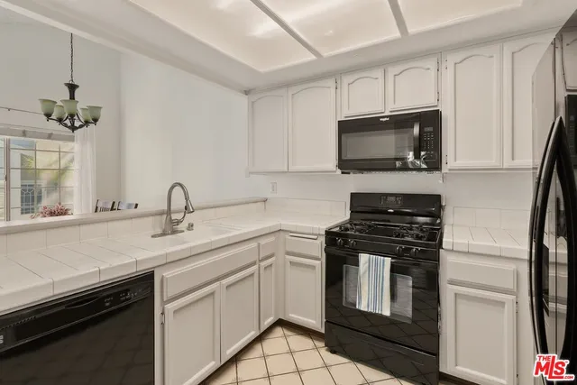a kitchen with a sink stove and microwave