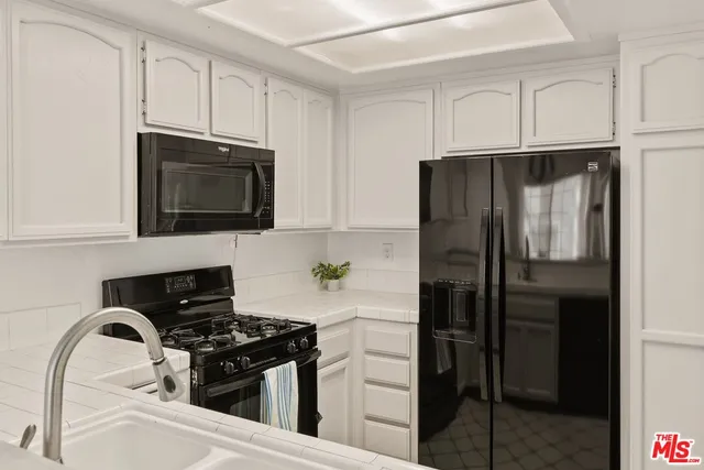 a kitchen with a refrigerator stove and microwave