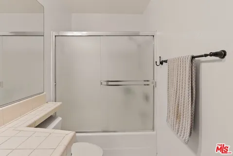 a bathroom with a shower and a toilet