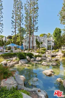 a view of swimming pool with outdoor seating and lake view