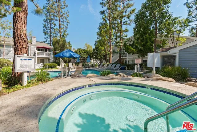 a swimming pool with outdoor seating and yard
