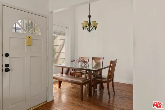 a view of a dining room with furniture wooden floor and a chandelier