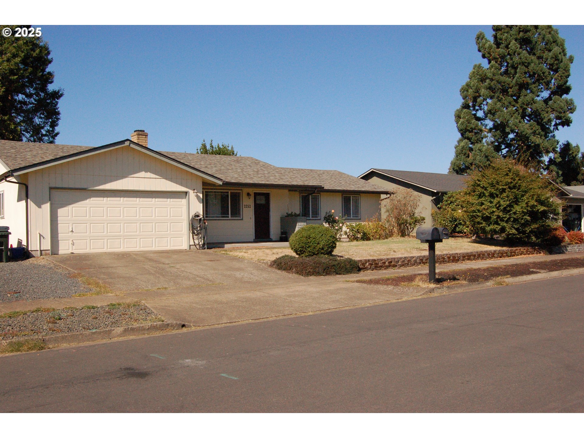 2252 Rose Blossom Drive Springfield, OR 97477 - Photo 3 of 26 a front view of a house with a yard