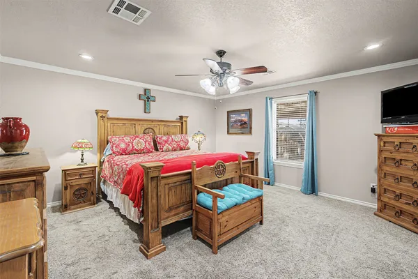 a bed room with a bed and a television
