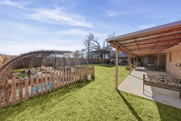a view of a backyard with sitting area