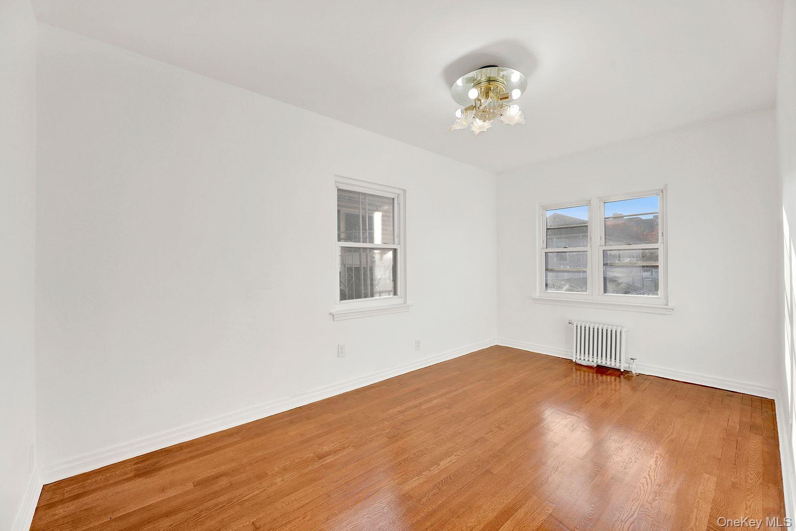 102-12 62nd Road Queens, NY 11375 - Photo 11 of 27 a view of empty room with wooden floor