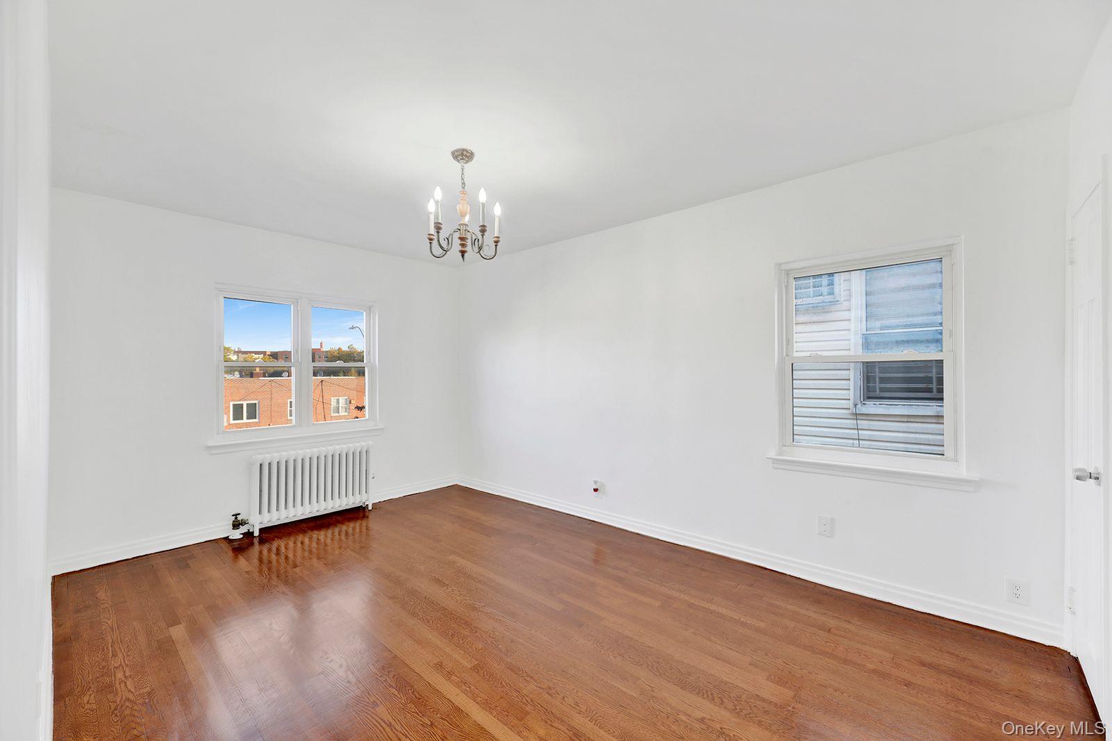 102-12 62nd Road Queens, NY 11375 - Photo 14 of 27 a view of empty room with wooden floor
