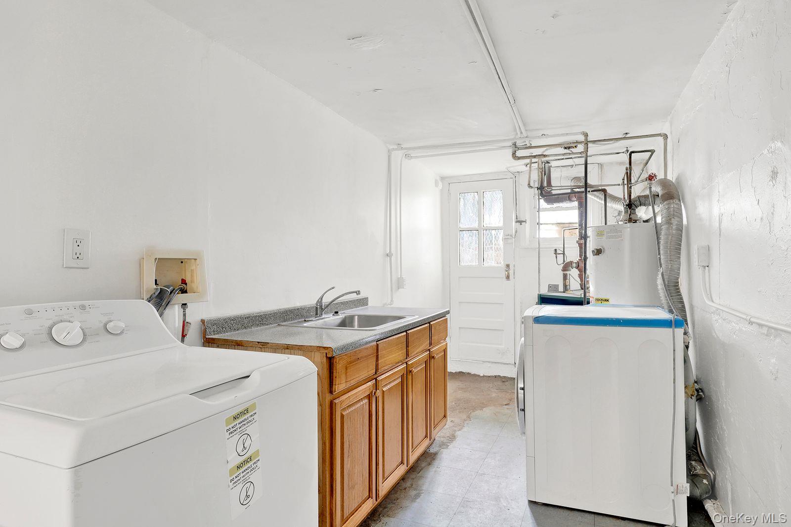 102-12 62nd Road Queens, NY 11375 - Photo 21 of 27 a utility room with dryer and washer