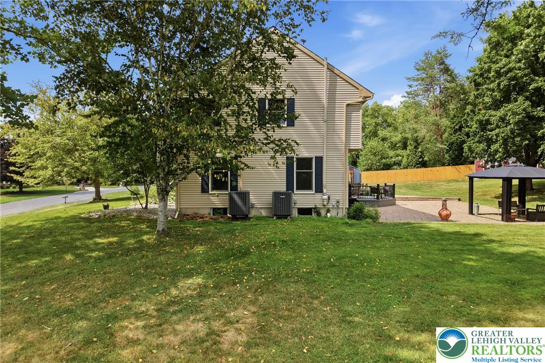 1553 Surrey Road Bethlehem, PA 18015 - Photo 71 of 92 A private backyard oasis awaits, featuring a spacious patio with a covered gazebo perfect for outdoor entertaining.
