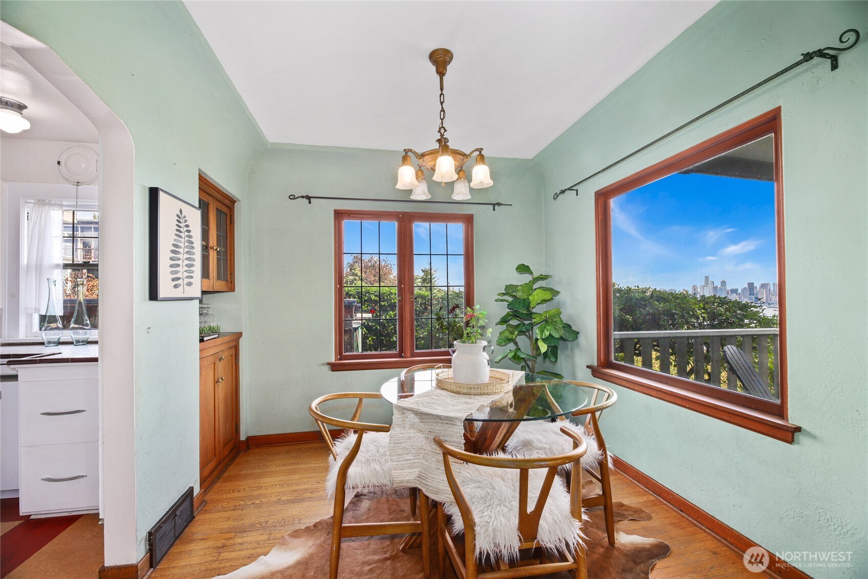 2309 Arch Avenue Southwest Seattle, WA 98116 - Photo 14 of 40 a dining room with furniture a chandelier and wooden floor