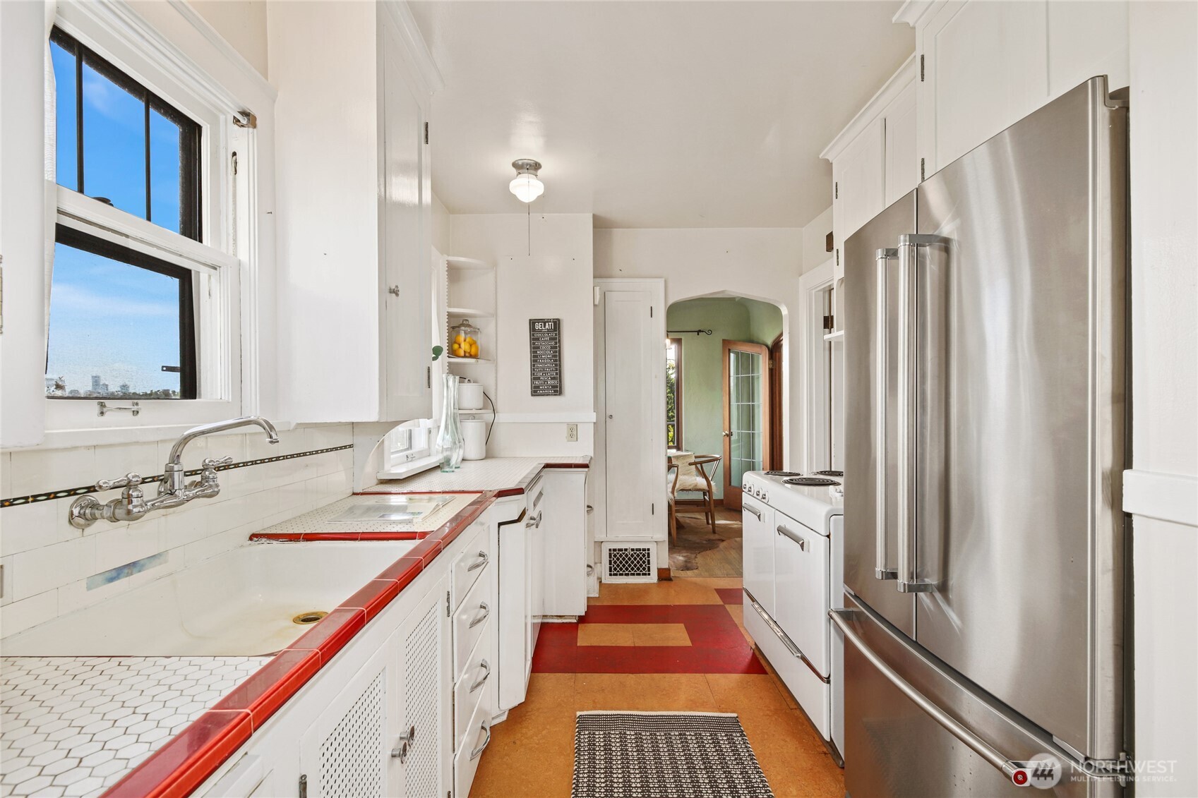 2309 Arch Avenue Southwest Seattle, WA 98116 - Photo 17 of 40 a bathroom with a double vanity sink and a mirror