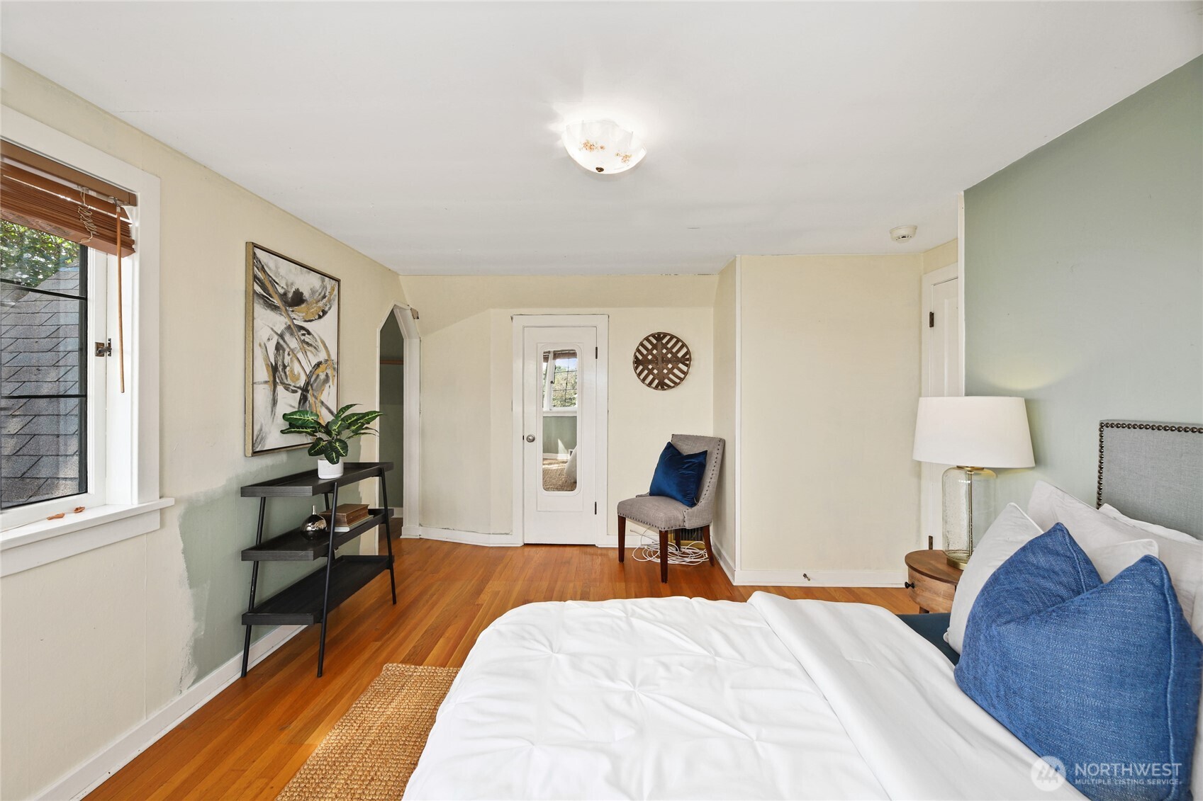 2309 Arch Avenue Southwest Seattle, WA 98116 - Photo 22 of 40 a bedroom with a bed and wooden floor