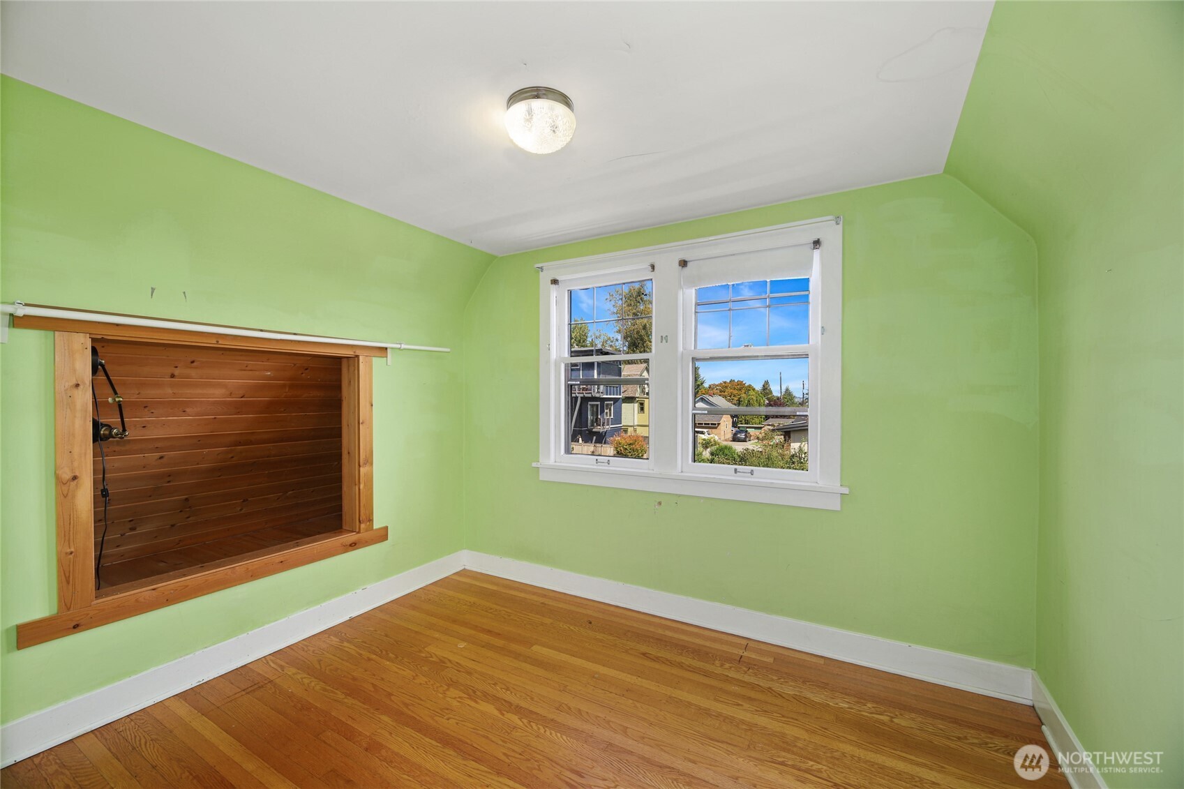 2309 Arch Avenue Southwest Seattle, WA 98116 - Photo 26 of 40 a view of an empty room with window and wooden floor