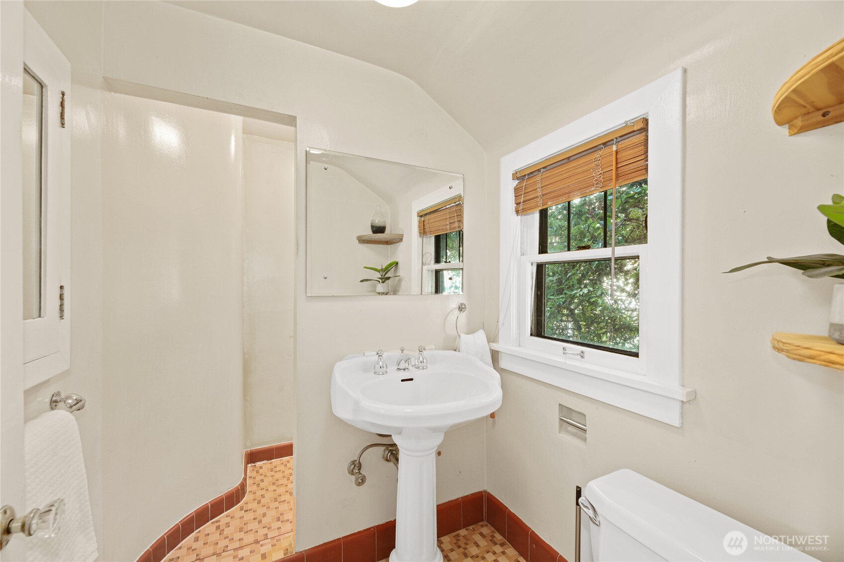 2309 Arch Avenue Southwest Seattle, WA 98116 - Photo 29 of 40 a bathroom with a sink a mirror and a toilet