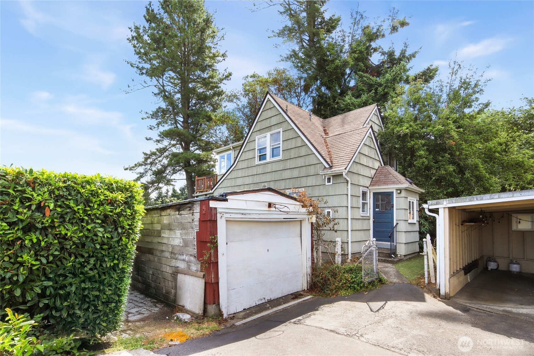 2309 Arch Avenue Southwest Seattle, WA 98116 - Photo 36 of 40 a view of a white house next to a yard and potted plants