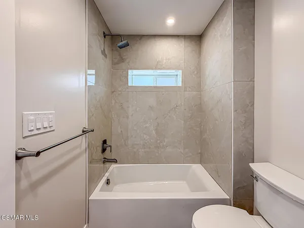 a bathroom with a bathtub and a toilet