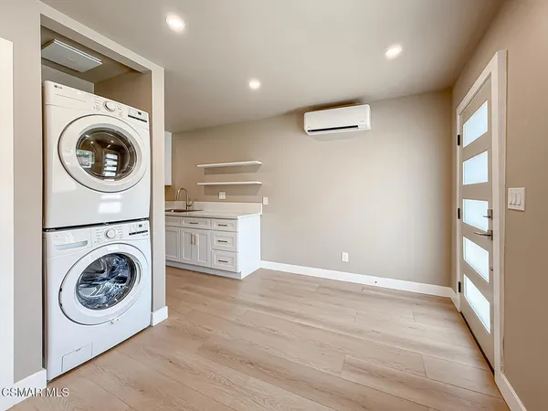 a view of a hallway with washer and dryer