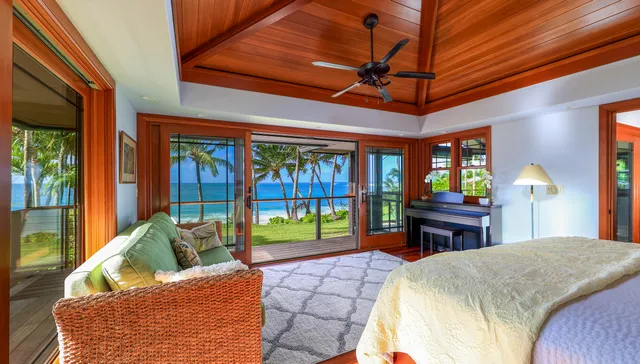 a bed room with a bed dresser and a large window