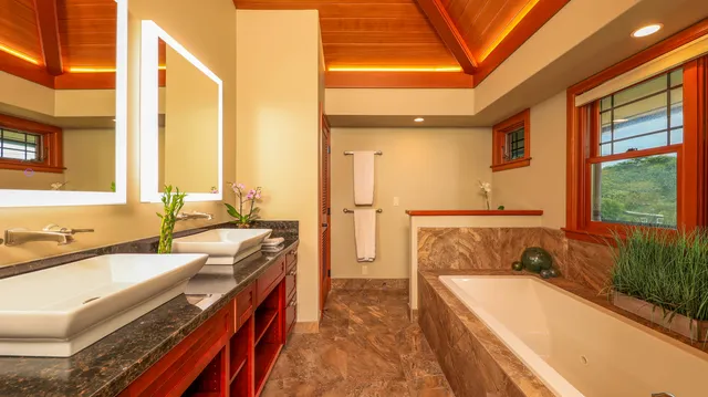 a spacious bathroom with a tub a double vanity sink a mirror and a bathtub