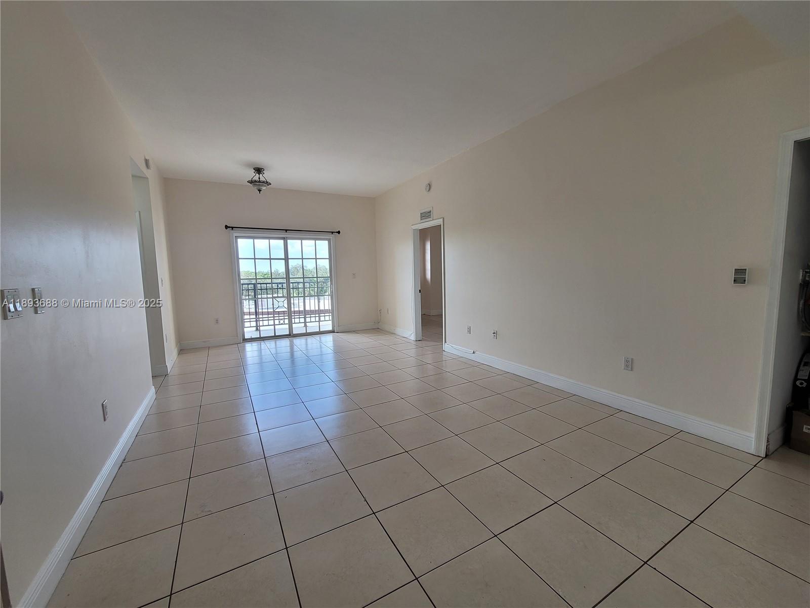 5271 Southwest 8th Street, Unit 411 Miami, FL 33134 - Photo 3 of 12 a view of an empty room and window