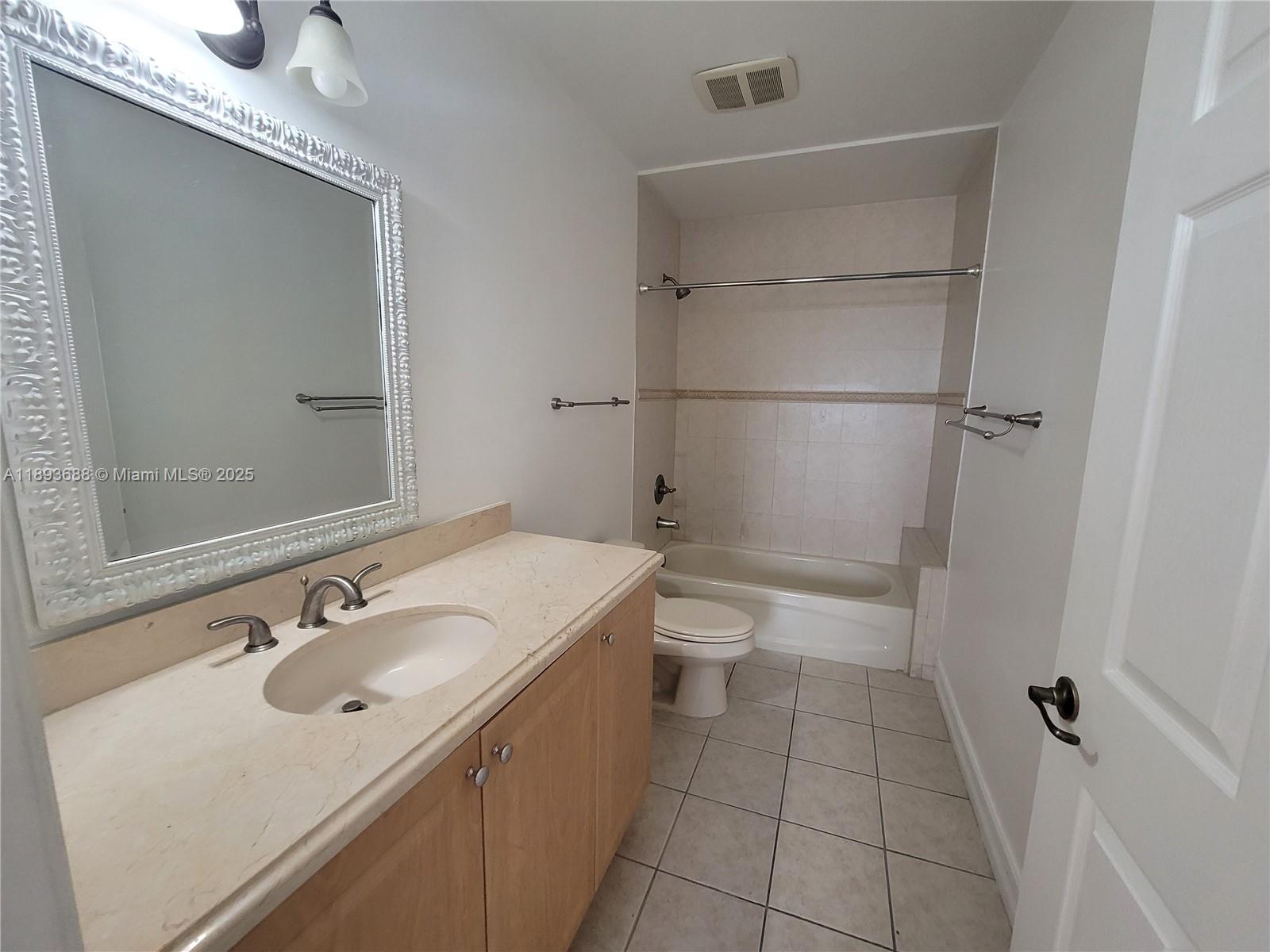 5271 Southwest 8th Street, Unit 411 Miami, FL 33134 - Photo 7 of 12 a bathroom with a sink toilet and shower