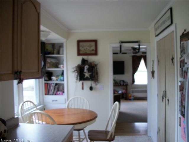 a dining room with furniture and a window