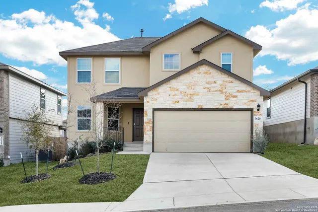 a view of white house with a yard and garage