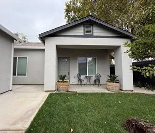 a front view of house with yard and outdoor seating