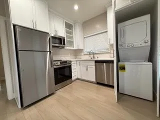 a kitchen with stainless steel appliances a refrigerator sink and cabinets