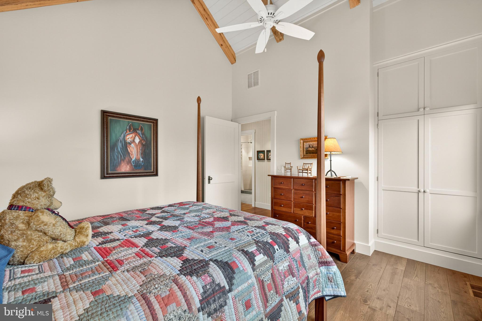 63 Riley Hollow Road Huntly, VA 22640 - Photo 37 of 92 a bedroom with a large bed and a chandelier