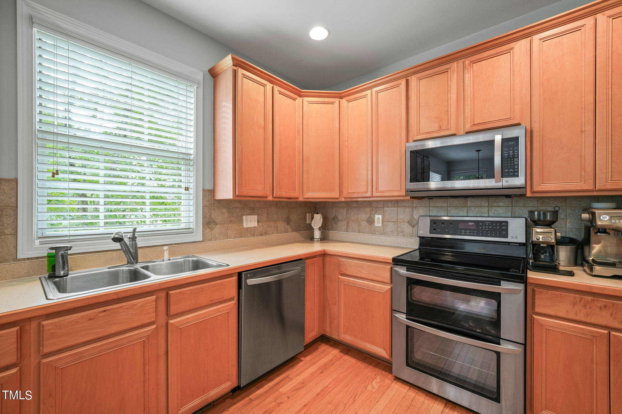 3 Piney Park Lane Durham, NC 27713 - Photo 16 of 47 a kitchen with granite countertop a sink cabinets stainless steel appliances and a window
