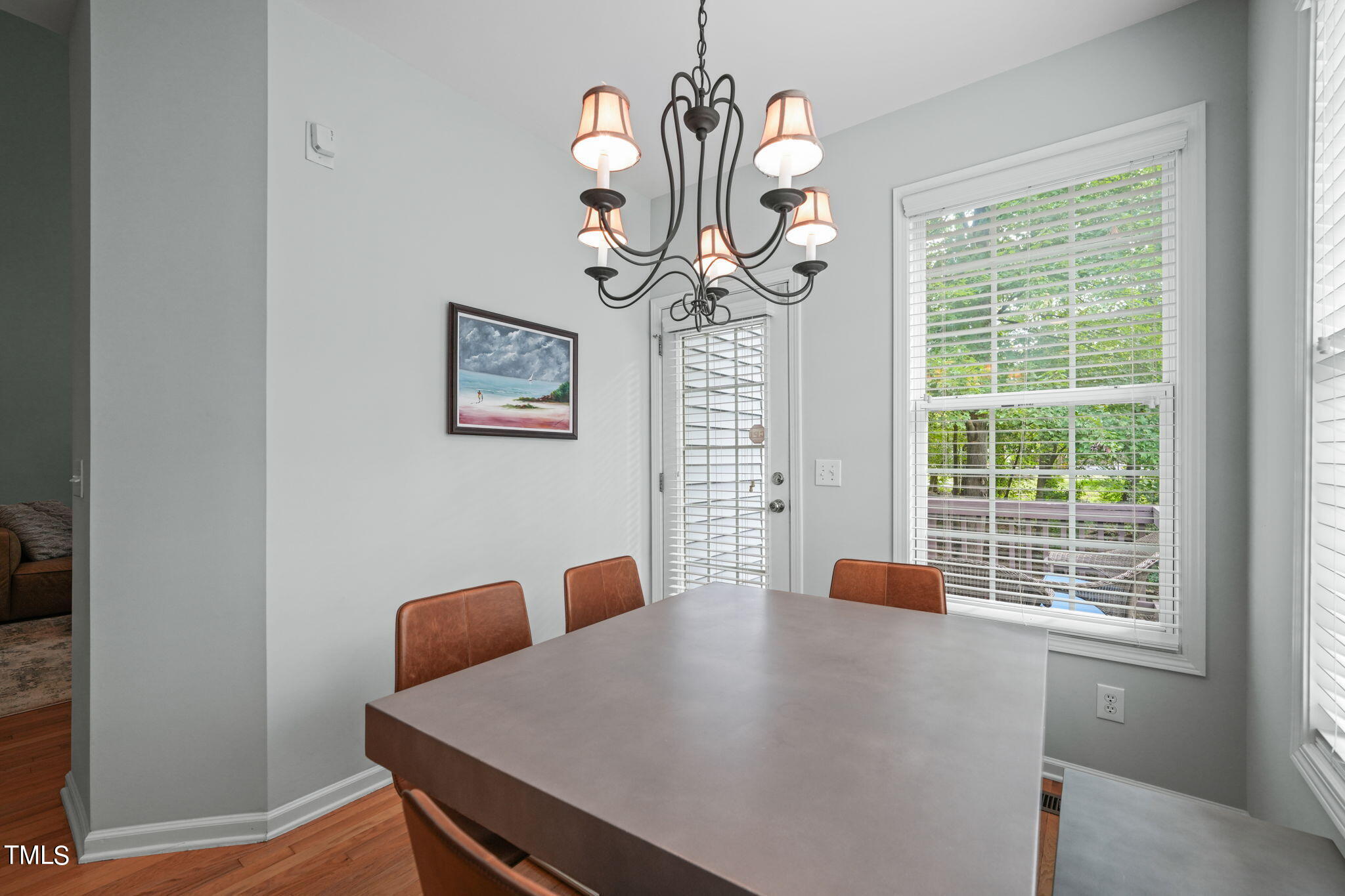 3 Piney Park Lane Durham, NC 27713 - Photo 19 of 47 a view of a dining room with furniture a chandelier and wooden floor