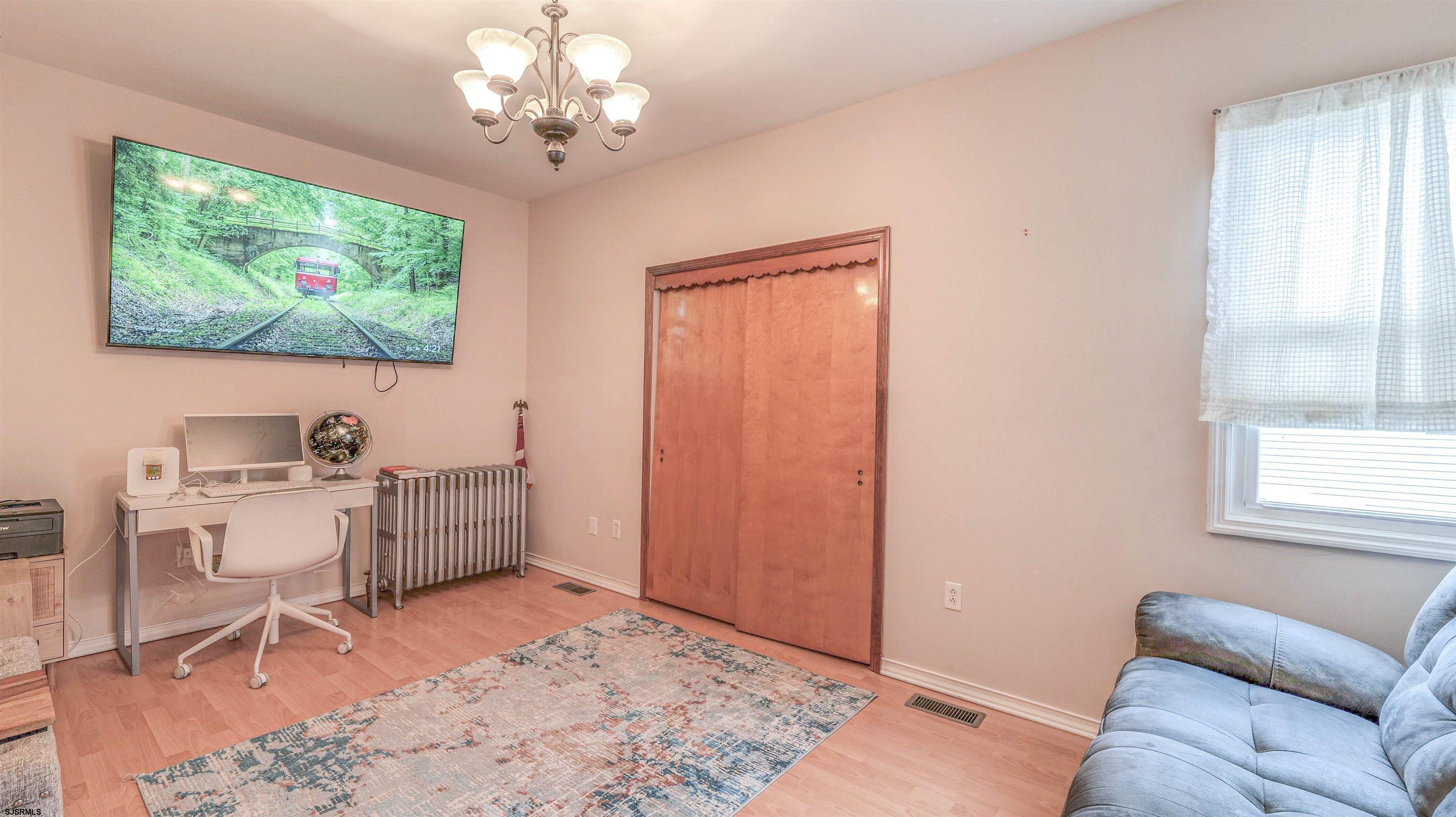 6015 Main Street Mays Landing, NJ 08330 - Photo 13 of 42 a living room with furniture a window and a flat screen tv