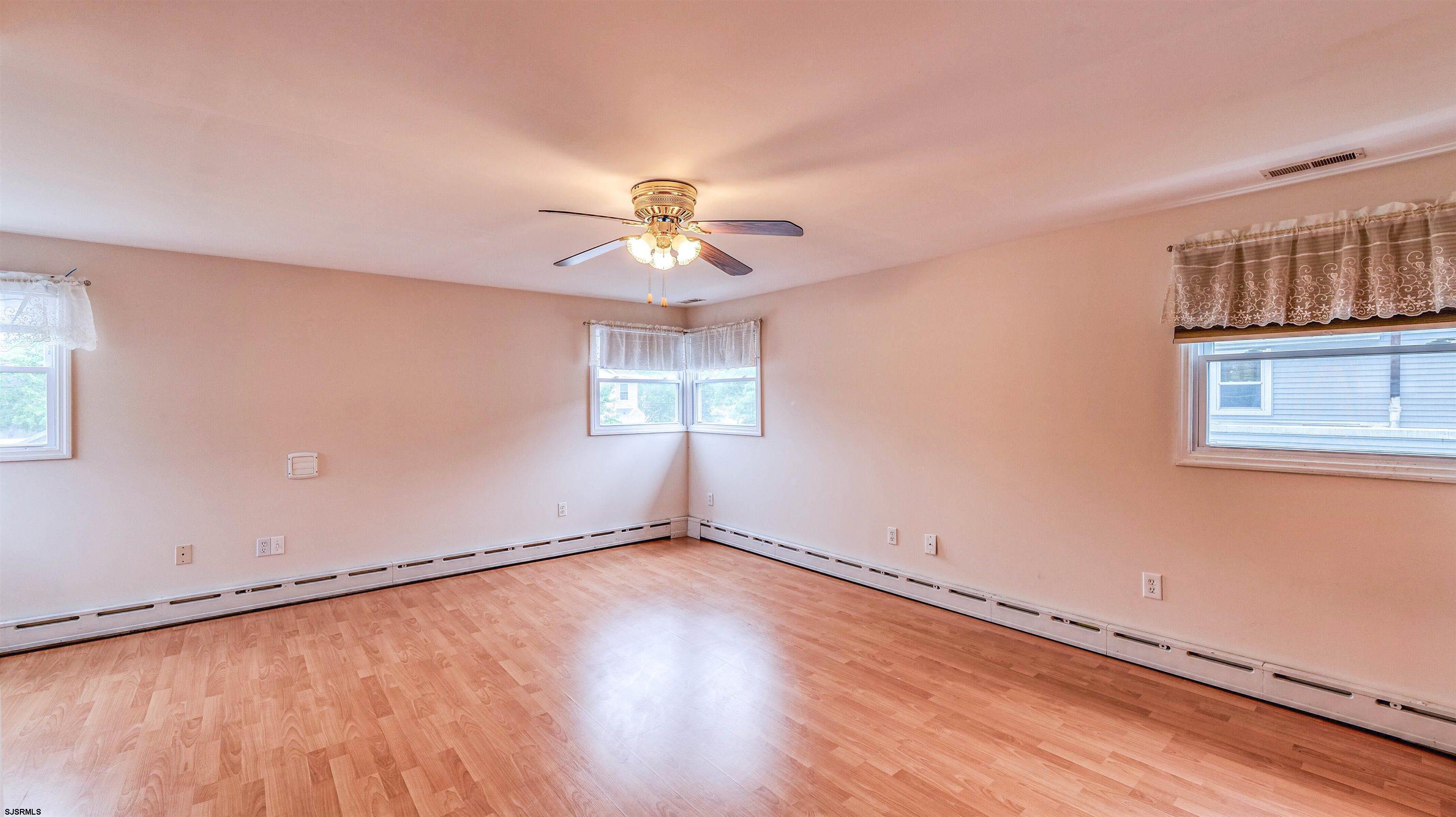 6015 Main Street Mays Landing, NJ 08330 - Photo 21 of 42 a view of an empty room with a window and wooden floor