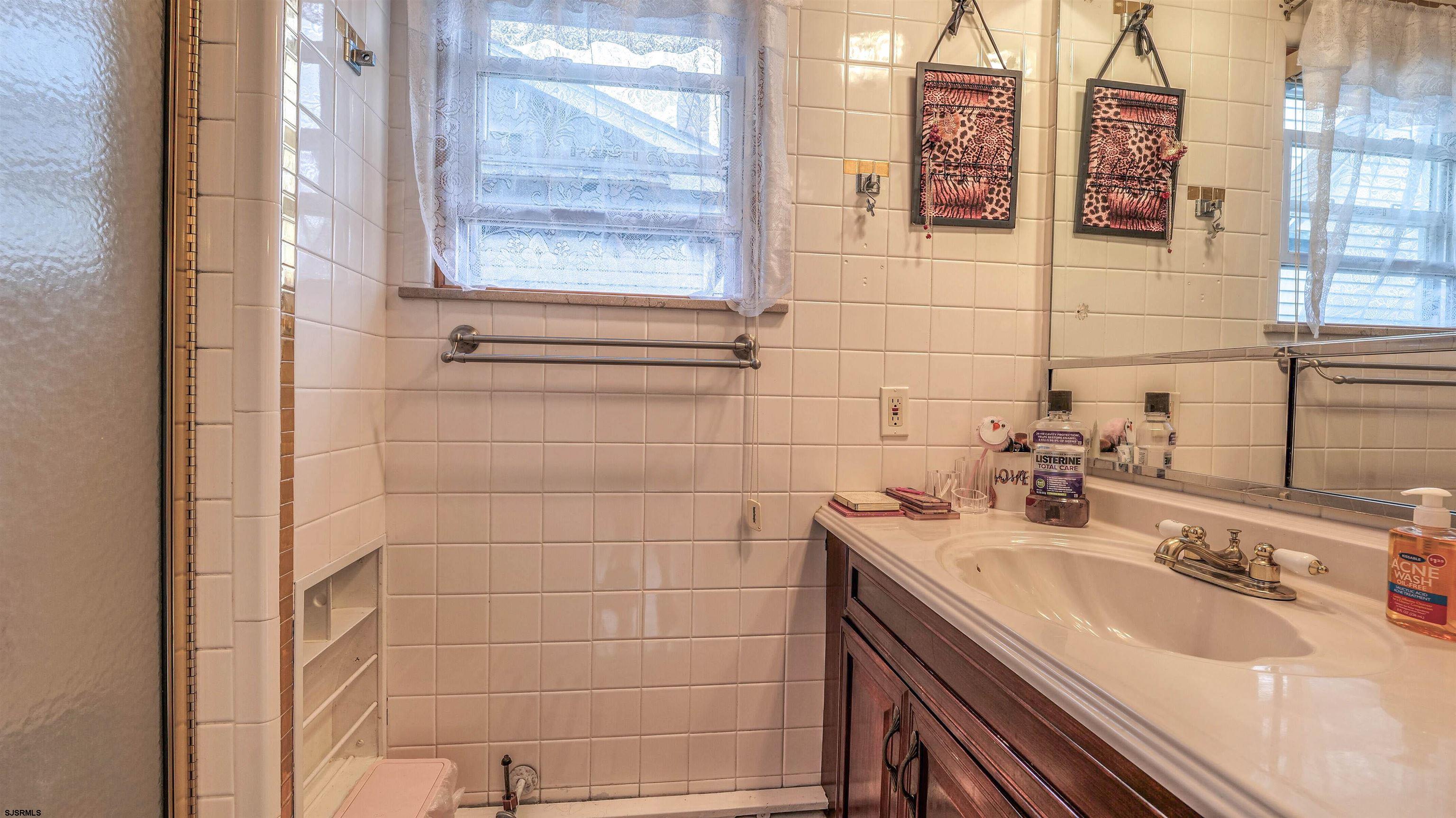 6015 Main Street Mays Landing, NJ 08330 - Photo 25 of 42 a bathroom with a sink and a mirror