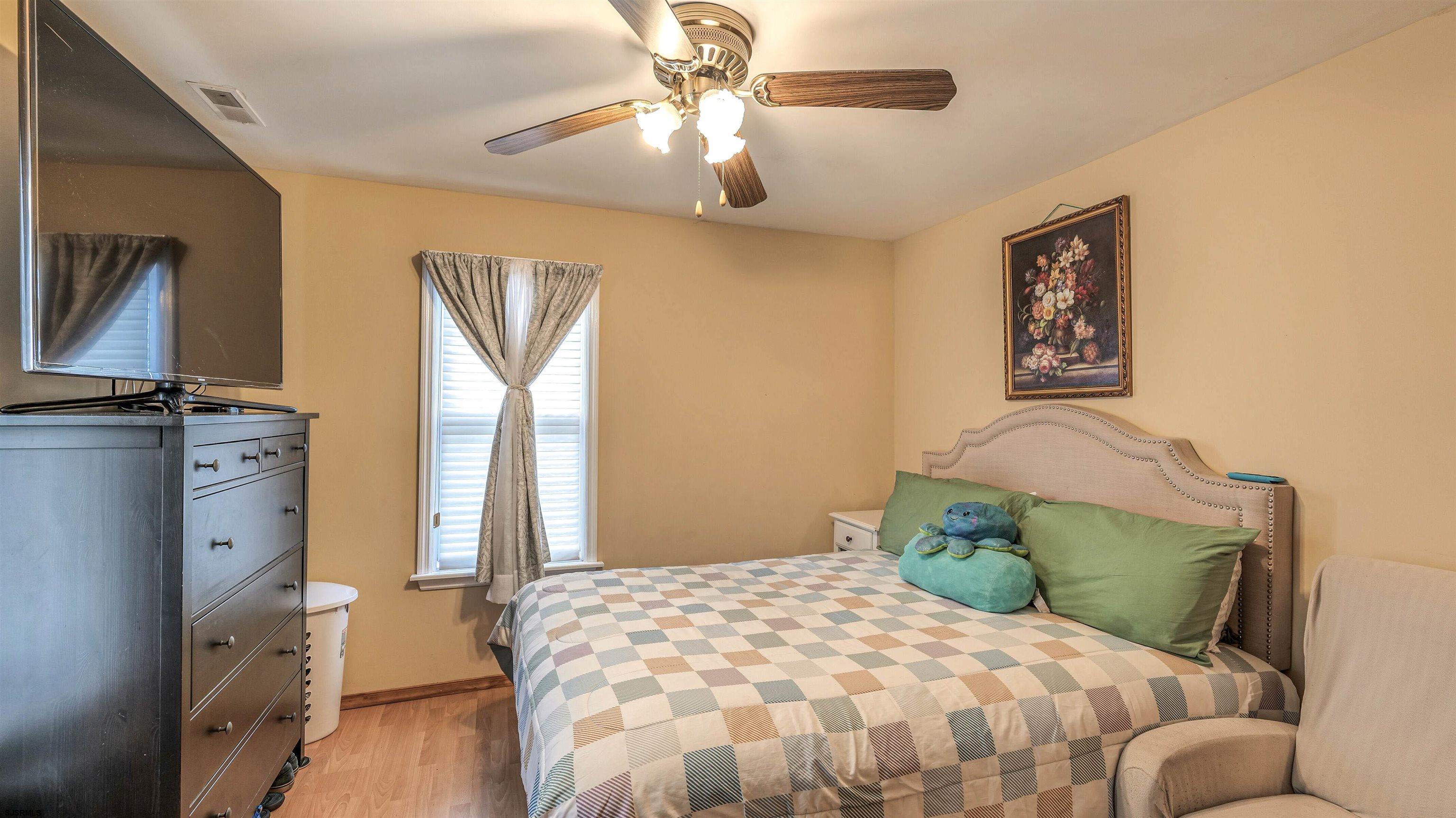 6015 Main Street Mays Landing, NJ 08330 - Photo 26 of 42 a bedroom with a bed and a chandelier