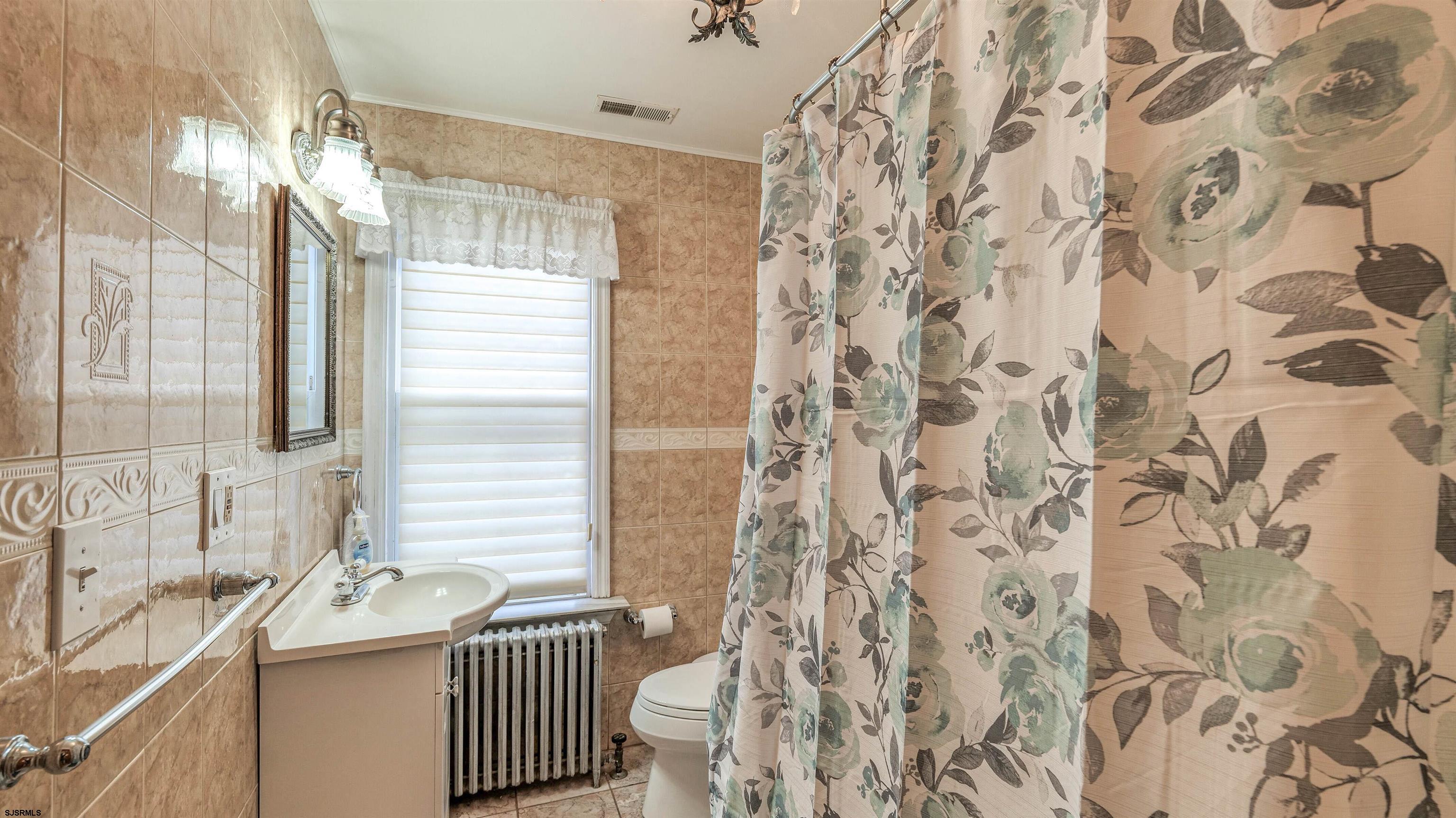 6015 Main Street Mays Landing, NJ 08330 - Photo 27 of 42 a bathroom with a sink and a mirror