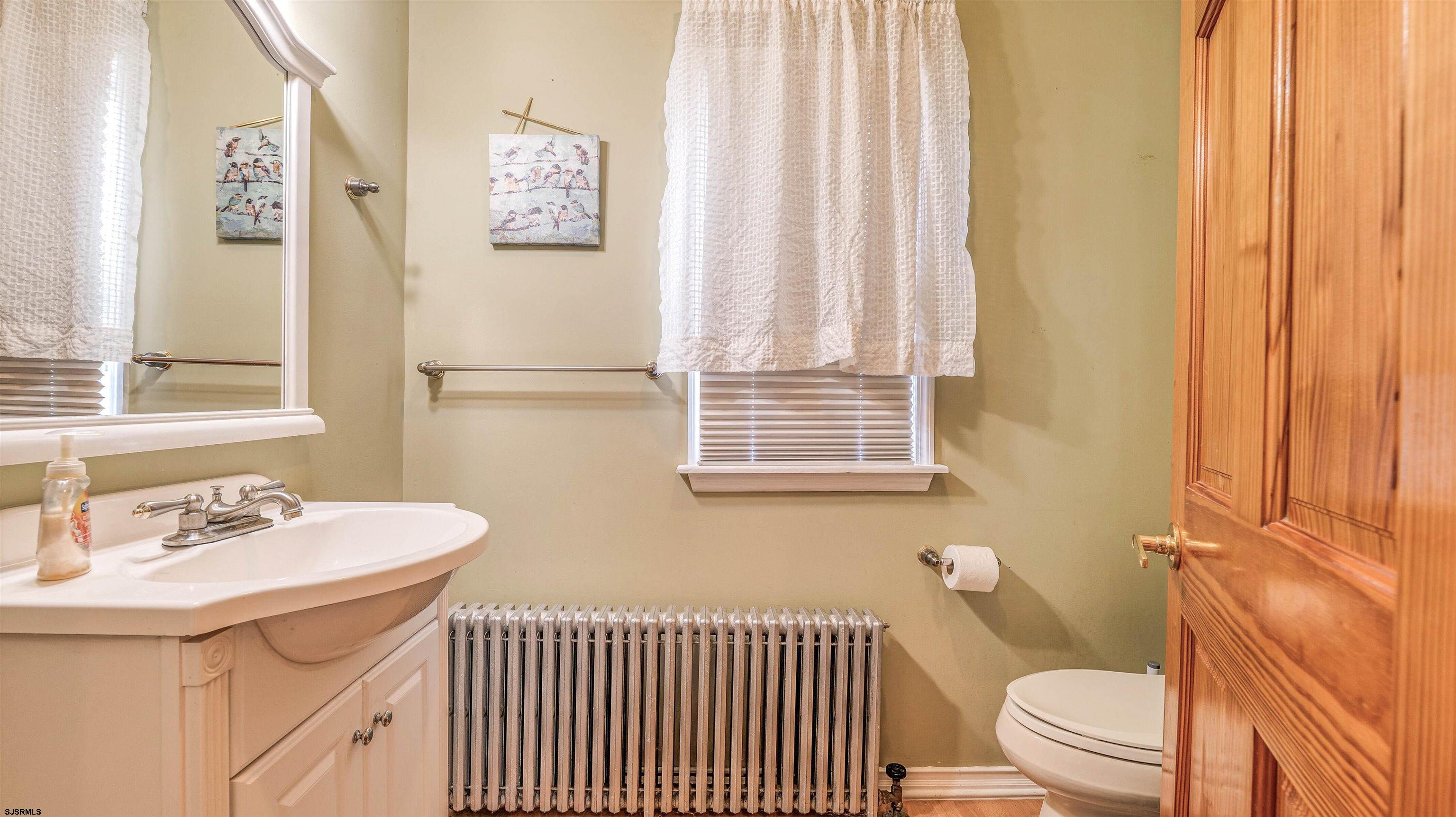 6015 Main Street Mays Landing, NJ 08330 - Photo 8 of 42 a bathroom with a sink a toilet and shower curtain