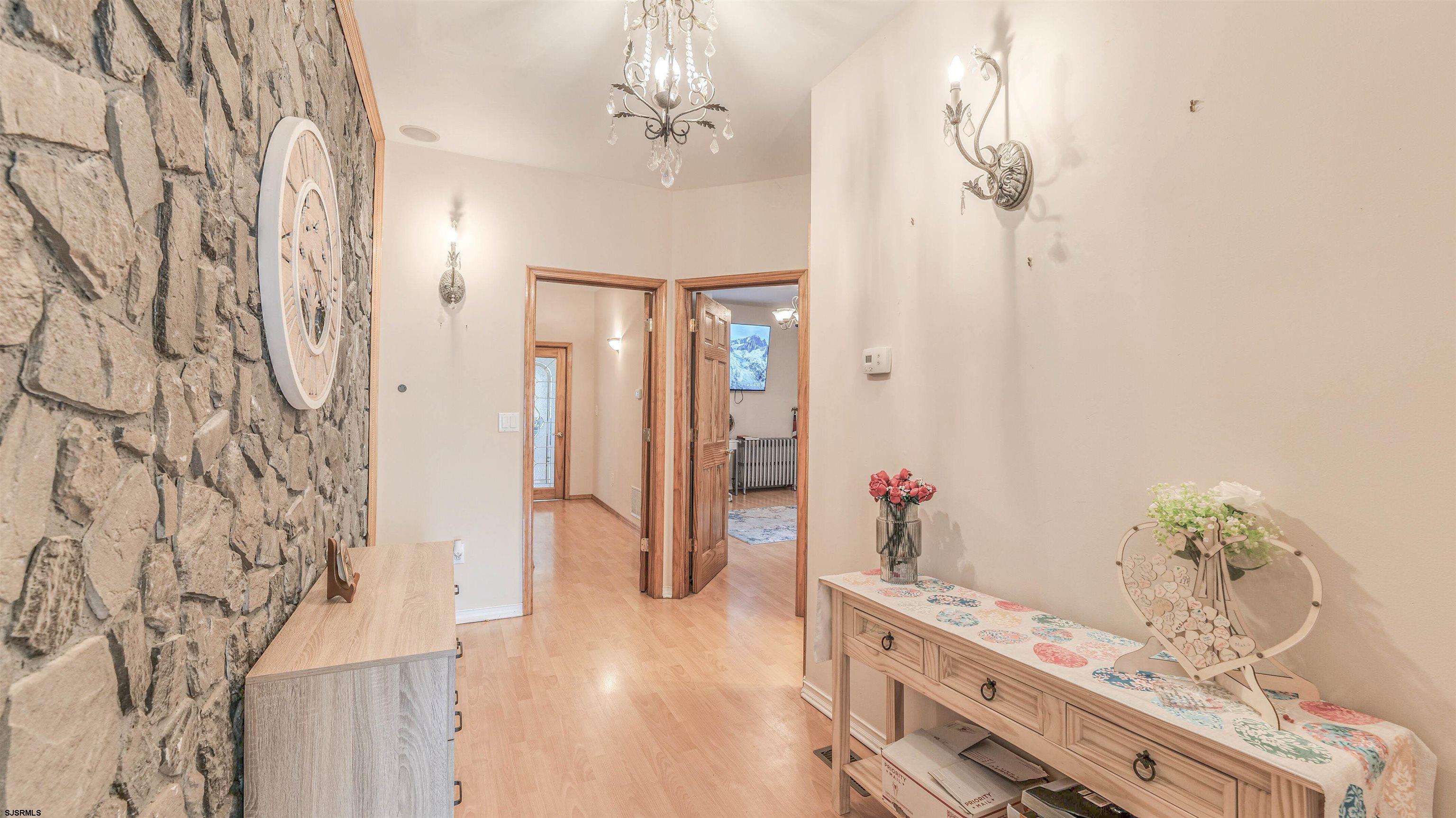 6015 Main Street Mays Landing, NJ 08330 - Photo 9 of 42 a view of a hallway with chandelier and wooden floor