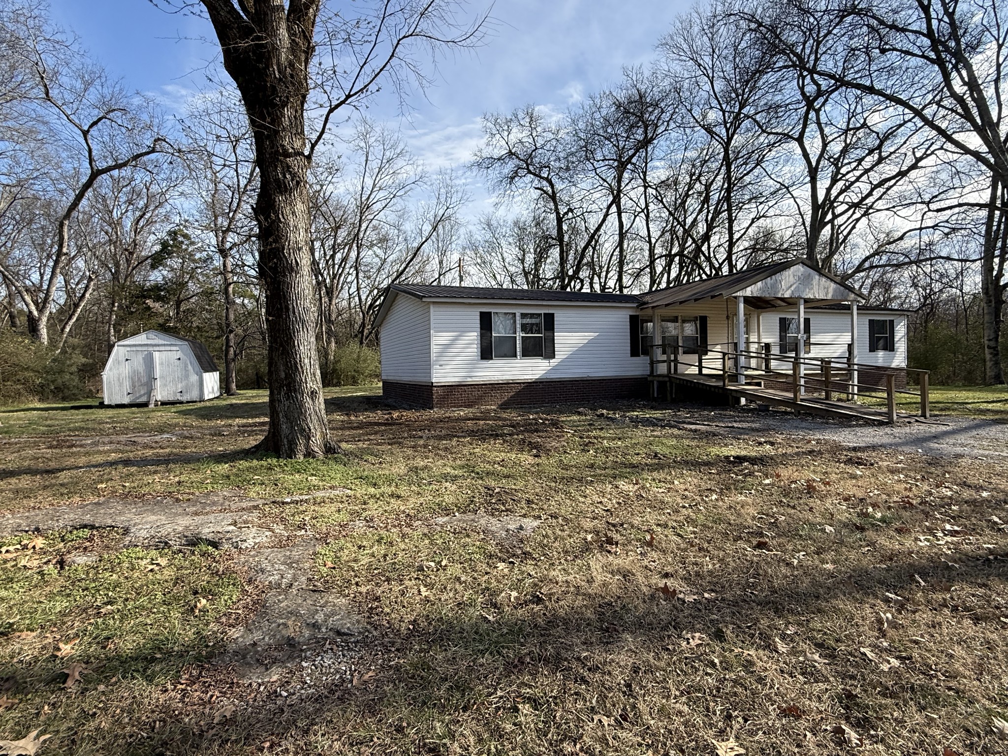 a house that has a tree in front of it