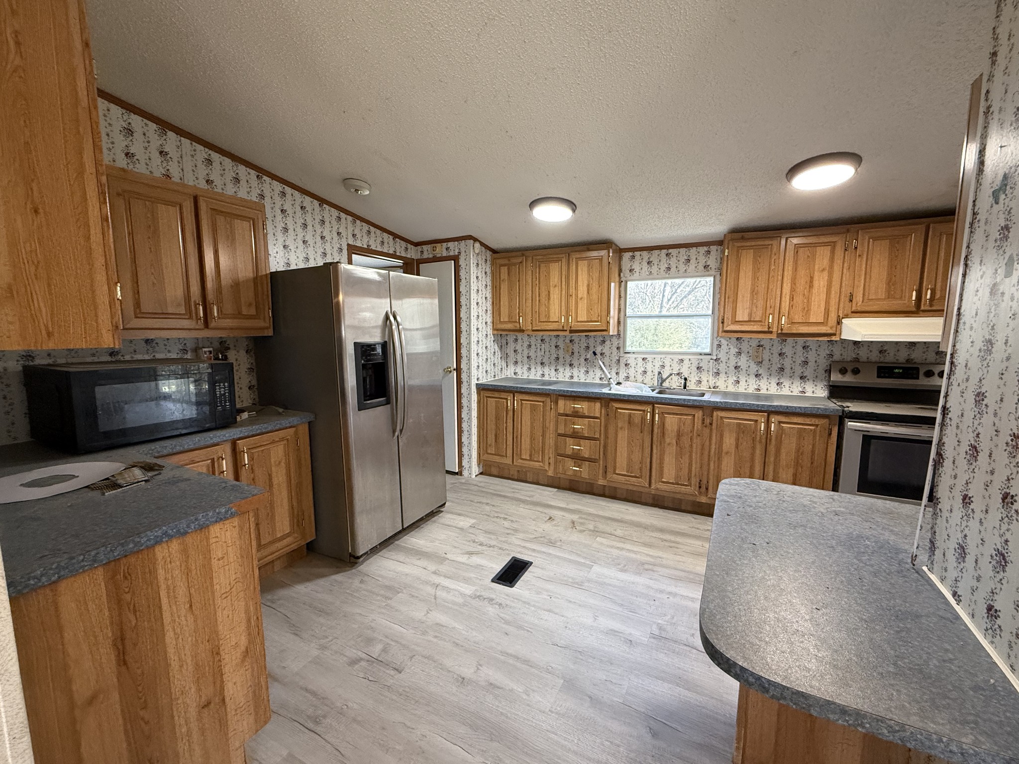 2421 Anes Station Road Lewisburg, TN 37091 - Photo 7 of 16 a kitchen with stainless steel appliances granite countertop a refrigerator a stove top oven a sink and dishwasher