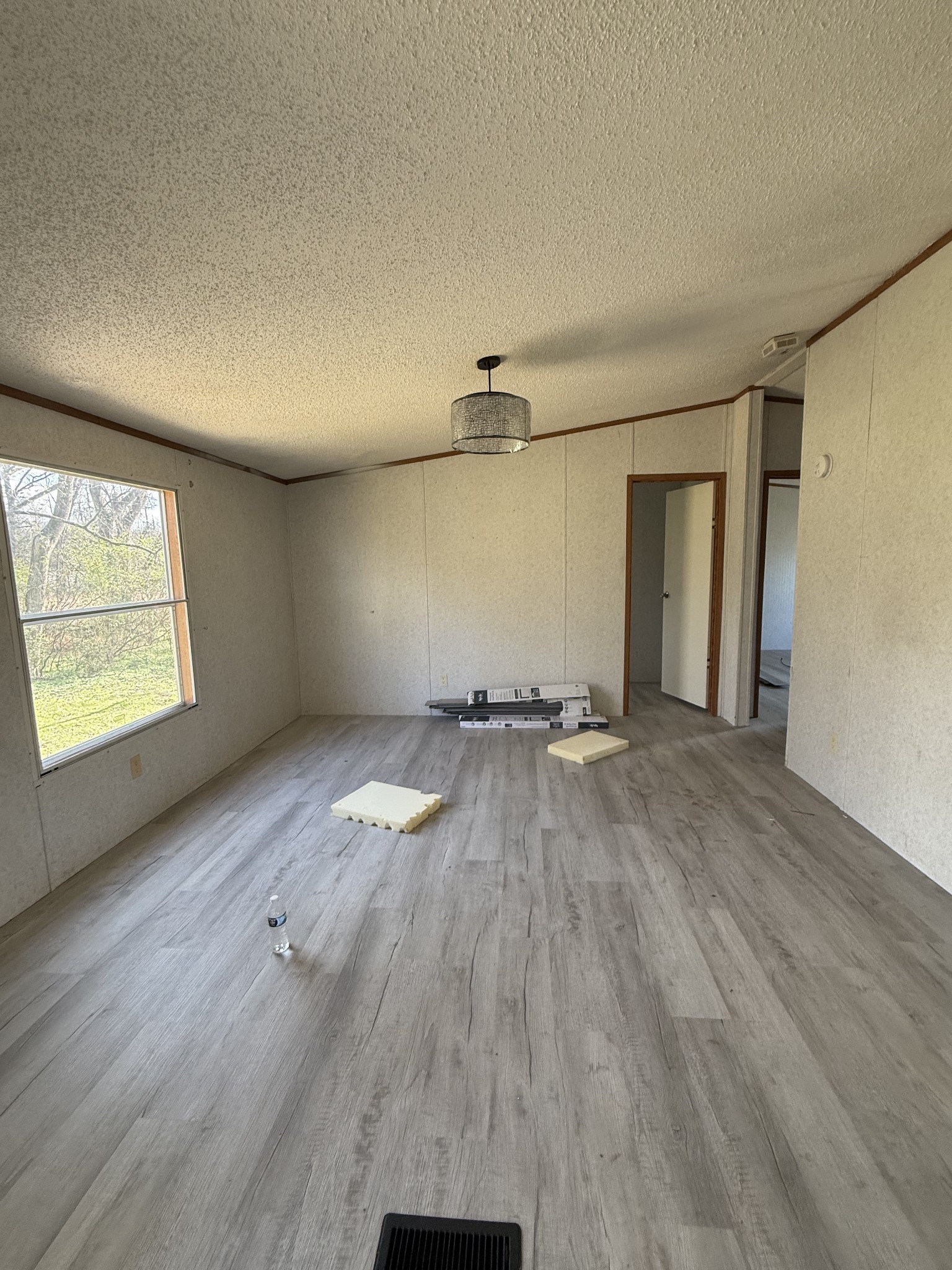 2421 Anes Station Road Lewisburg, TN 37091 - Photo 8 of 16 an empty room with wooden floor and windows