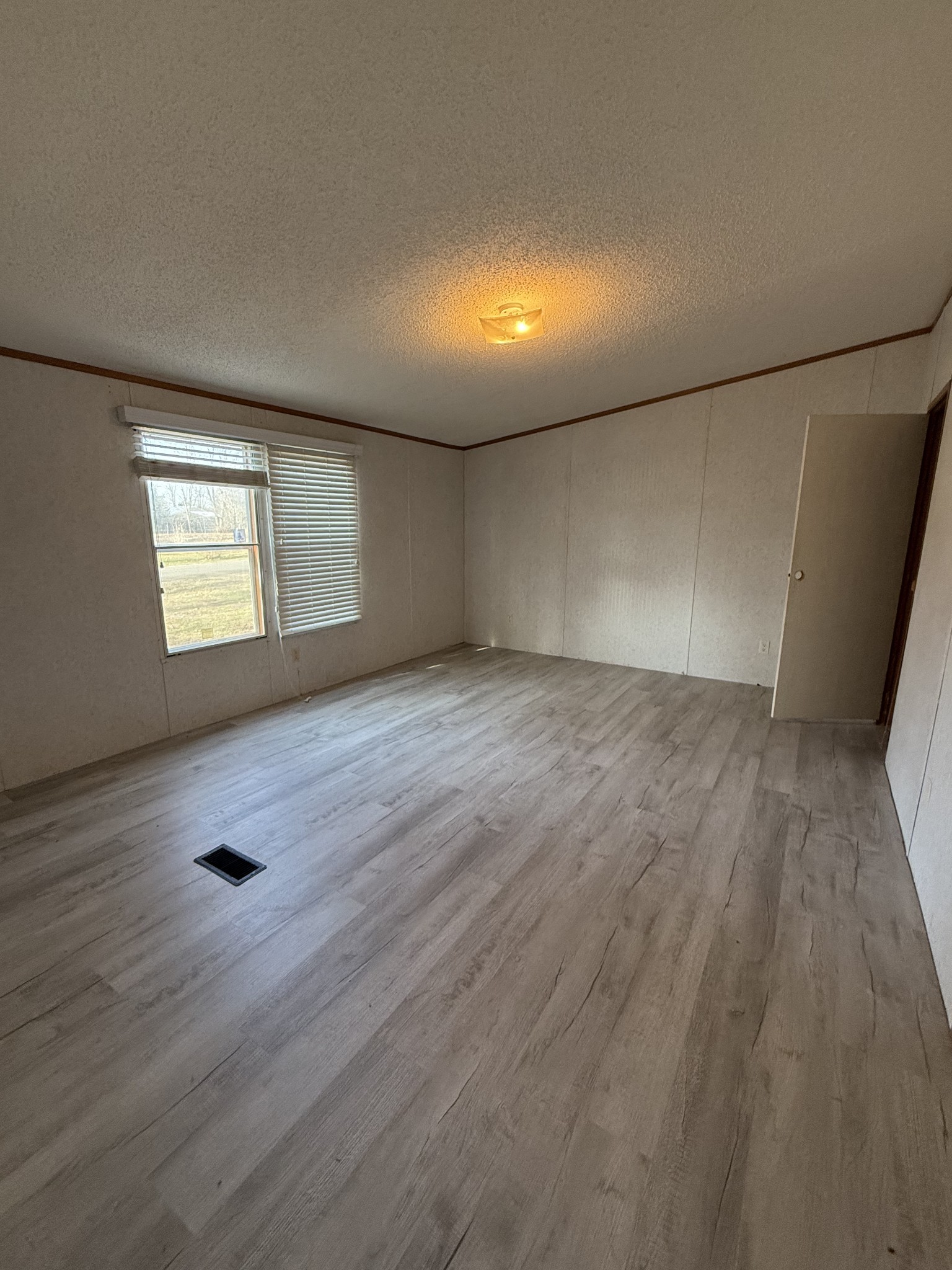 2421 Anes Station Road Lewisburg, TN 37091 - Photo 10 of 16 an empty room with wooden floor and windows