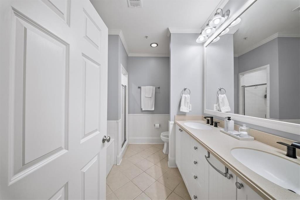 4100 Paces Walk Southeast, Unit 1101 Atlanta, GA 30339 - Photo 16 of 36 a spacious bathroom with a double vanity sink a mirror and a shower