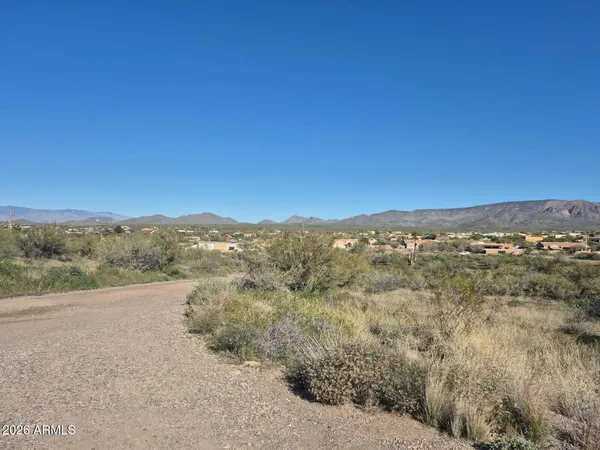 a view of a large mountain with mountains in the background